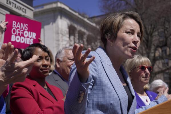 Gov. Maura Healey, front right, faces reporters as Massachusetts Attorney General Andrea Campbell, left, looks on, Monday, April 10, 2023, during a news conference in front of the Statehouse, in Boston. Massachusetts is stockpiling enough doses of mifepristone to last for more than a year Healey, a Democrat, said Monday. (AP Photo/Steven Senne)