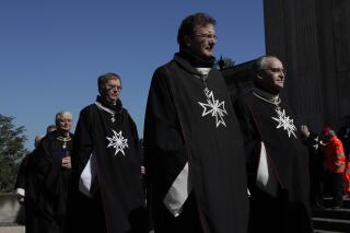 FILE - Albrecht von Boeselager, second from right, walks in procession along with other Knights of Malta before the election of the new Grand Master, at the order's Villa Magistrale on Rome's Aventine Hill ahead of the secret balloting on April 29, 2017. The Knights’ grand chancellor, Albrecht von Boeselager, wrote a letter to the Knights’ members saying the Vatican proposals contradict assurances he had been given that Pope Francis doesn’t want to put the order’s sovereignty at risk. (AP Photo/Alessandra Tarantino)
