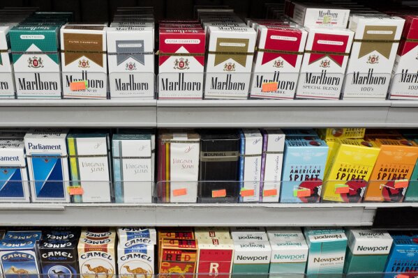 
              FILE - This Monday, Aug. 28, 2017 file photo shows cigarettes displayed on a store shelf in New York.
On Friday, Feb. 16, 2018, The Associated Press has found that stories circulating on the internet that Philip Morris Marlboro ‘M’ brand marijuana brand cigarettes are now for sale in four U.S. states are untrue. (AP Photo/Mark Lennihan)
            