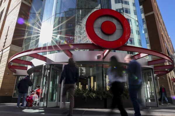 Pedestrians pass a Target store near the Target Corporation's headquarters Thursday, Jan. 30, 2025, in Minneapolis, Minn. (AP Photo/Ellen Schmidt)