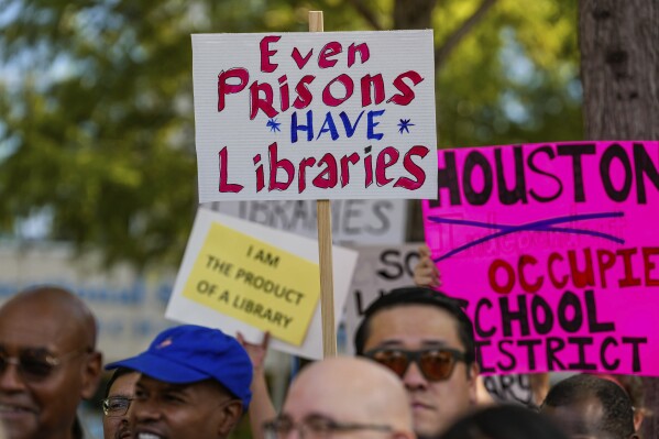 Community members, teachers, parents, students and elected officials protest the closing of libraries in Houston's Independent School District schools outside the Hattie Mae White Educational Service Center on Saturday, Aug. 5, 2023, in Houston. (Raquel Natalicchio/Houston Chronicle via AP)
