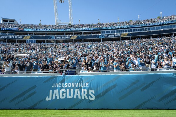 FILE - Jacksonville Jaguars fans cheer during an NFL football game at EverBank Stadium, Sunday, Oct. 15, 2023, in Jacksonville, Fla. The Jaguars and the city of Jacksonville have agreed to a $1.4 billion “stadium of the future” that would keep the franchise in one of the NFL's smallest markets for another 30 years. The plan was presented at a city council meeting Tuesday., May 14, 2024. (Ǻ Photo/Alex Menendez, File)