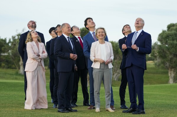 FILE -From right, U.S. President Joe Biden, French President Emmanuel Macron, European Commission President Ursula von der Leyen, Canada's Prime Minister Justin Trudeau, Japan's Prime Minister Fumio Kishida, German Chancellor Olaf Scholz, Britain's Prime Minister Rishi Sunak, Italian Prime Minister Giorgia Meloni and European Council President Charles Michel watch a skydiving demo during the G7 world leaders summit at Borgo Egnazia, Italy, Thursday, June 13, 2024. Leaders of the Group of Seven leading industrialized nations are turning their attention to migration on the second day of their summit Friday. (AP Photo/Domenico Stinellis, File)