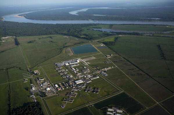 In this aerial photo, the Louisiana State Penitentiary lies along the bending Mississippi River, Friday, July 21, 2023, in Angola, La. The former 19th-century antebellum plantation once was owned by one of the largest slave traders in the U.S. It spans 18,000 acres – an area bigger than the island of Manhattan – and has its own ZIP code.(AP Photo/Gerald Herbert)