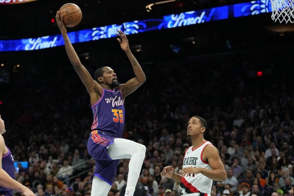 Phoenix Suns forward Kevin Durant (35) dunks against the Portland Trail Blazers during the second half of an NBA In-Season Tournament basketball game, Tuesday, Nov. 21, 2023, in Phoenix. (AP Photo/Matt York)