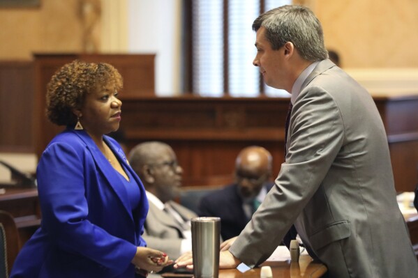 South Carolina Sen. Tameika Isaac Devine, D-Columbia, left, talks to Senate Majority Leader Shane Massey, R-Edgefield, right, after Devine was sworn in as a new state senator on Tuesday, Jan. 9, 2024. (AP Photo/Jeffrey Collins)