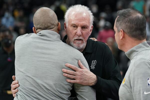 San Antonio Spurs head coach Gregg Popovich, center, talks with Los Angeles Lakers head coach Frank Vogel, right, and assistant coach David Fizdale, left, after winning an NBA basketball game, Monday, March 7, 2022, in San Antonio. (AP Photo/Eric Gay)