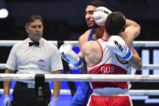 Russia's Muslim Gadzhimagomedov, red, fights with Italia's Aziz Abbes Mouhiidine during the men's heavyweight final of the IBA Boxing World Championships, in Tashkent, Uzbekistan, Sunday, May 14, 2023. (AP Photo)