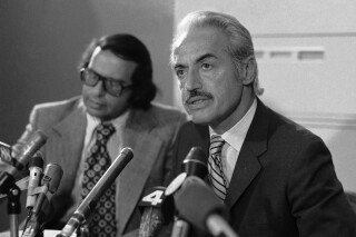 Marvin Miller, right, executive director of the Major League Baseball Players Association tells newsmen, April 3, 1972 that the association has made a proposal to Major League owners in an effort to end the first general players strike in baseball. Listening at left is Dick Moss, players association lawyer. Miller spoke at a news conference following a meeting with owners representative, John Gaherin. (AP Photo)