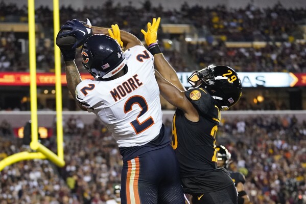 Chicago Bears wide receiver DJ Moore (2) making a touchdown catch against Washington Commanders cornerback Kendall Fuller (29) during the first half of an NFL football game, Thursday, Oct. 5, 2023, in Landover, Md. (AP Photo/Alex Brandon)