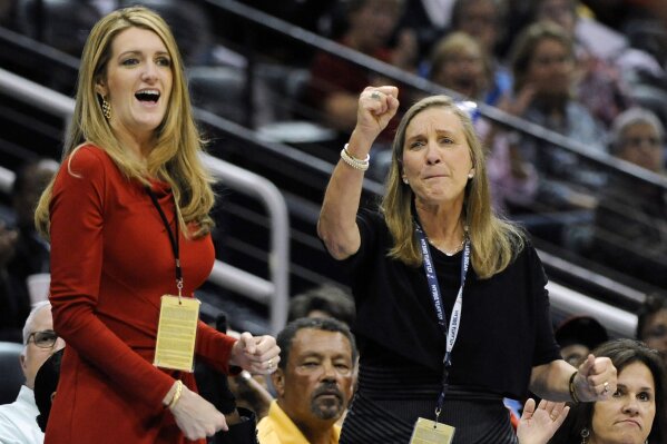 FILE-In this Sept. 6, 2011 file photo, Mary Brock, right, and Kelly Loeffler cheer from their courtside seats as the Atlanta Dream basketball team plays in the second half of their WNBA basketball game, in Atlanta. A GOP political consultant told The Associated Press that Georgia Gov. Brian Kemp decided to appoint Loeffler, a Republican donor and financial services executive, to succeed retiring Sen. Johnny Isakson. Kemp is set to formally announce his choice on Wednesday morning, Dec. 4, 2019. (AP Photo/David Tulis, File)