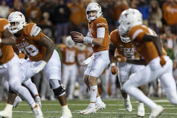 Texas quarterback Quinn Ewers (3) looks for a receiver during the second half of the team's NCAA college football game against TCU on Saturday, Nov. 12, 2022, in Austin, Texas. (AP Photo/Stephen Spillman)