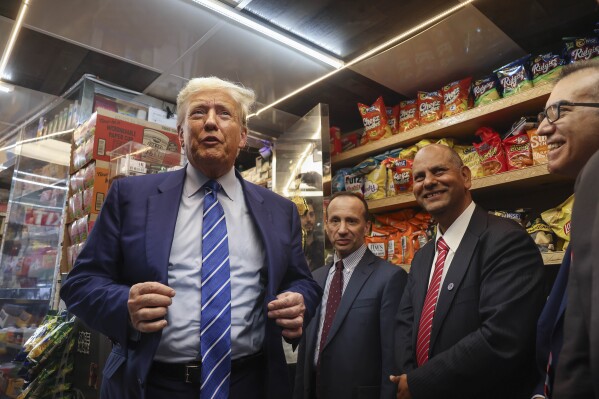 FILE - Republican presidential candidate former President Donald Trump, left, visits a bodega, April 16, 2024, in New York. Five months before the first general election votes are cast, Trump's campaign has little to show for its ambitious minority outreach plan. Trump advisers point to Trump's appearances at the bodega, an Atlanta Chick-fil-A, and a New York City police officer's wake, as examples of the campaign's developing outreach strategy that hinges on using Trump's celebrity and bombastic personality to create viral moments in communities of color. (AP Photo/Yuki Iwamura, File)