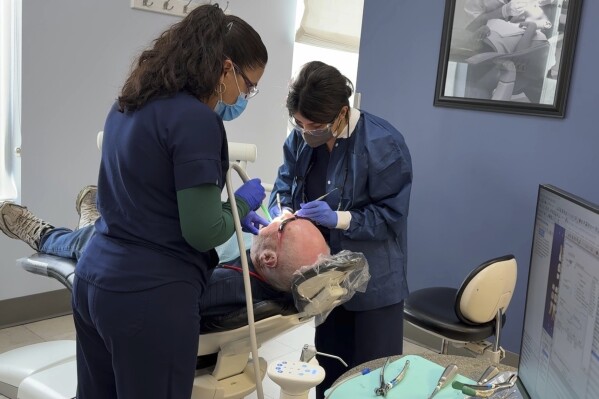A patient receives a dental procedure at Salt Lake Donated Dental Services, a clinic serving low-income Utah residents, Monday, May 5, 2025, in Salt Lake City, Utah. (AP Photo/Hannah Schoenbaum)