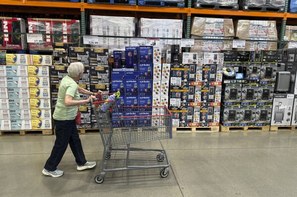A shopper surveys goods on display in a Costco warehouse Wednesday, May 21, 2025, in Lone Tree, Colo. (AP Photo/David Zalubowski)