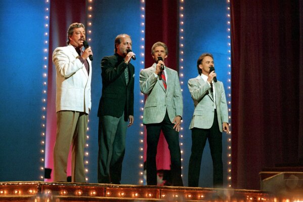 FILE - In this June 5, 1989, file photo, The Statler Brothers, from left, Harold Reid, Don Reid, Phil Balsley and Jimmy Fortune, perform at the 23rd annual Music City News Country Awards show in Nashville, Tenn. Harold Reid, who sang bass for the Grammy-winning country group The Statler Brothers, died Friday, April 24, 2020, after a long battle with kidney failure. He was 80. (AP Photo/Mark Humphrey, File)