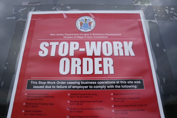 A stop work order is posted on the door of a Boston Market restaurant in Hackensack, N.J., Thursday, Aug. 17, 2023. State labor officials have temporarily shut down more than two dozen Boston Market restaurants in New Jersey after an investigation sparked by worker complaints found multiple violations of workers' rights, including more than $600,000 in back wages owed to 314 employees.(AP Photo/Seth Wenig)