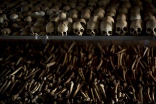 FILE - In this Friday, April 4, 2014 file photo, the skulls and bones of some of those who were slaughtered as they sought refuge inside the church are laid out as a memorial to the thousands who were killed in and around the Catholic church during the 1994 genocide in Ntarama, Rwanda. France's highest court on Wednesday Sept.30, 2020 rejected Rwandan genocide suspect Félicien Kabuga's appeal of a decision to extradite him to an international court in The Hague. Kabuga, one of the most-wanted fugitives in Rwanda's 1994 genocide, was arrested outside Paris in May after 25 years on the run. (AP Photo/Ben Curtis, File)