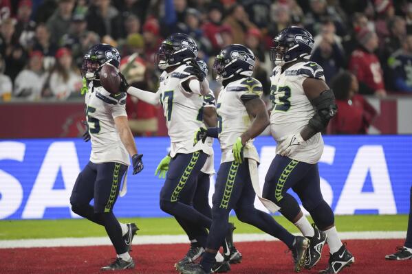 Seattle Seahawks' Tariq Woolen (27) reacts after an interception during the second half of an NFL football game against the Tampa Bay Buccaneers, Sunday, Nov. 13, 2022, in Munich, Germany. (AP Photo/Matthias Schrader)
