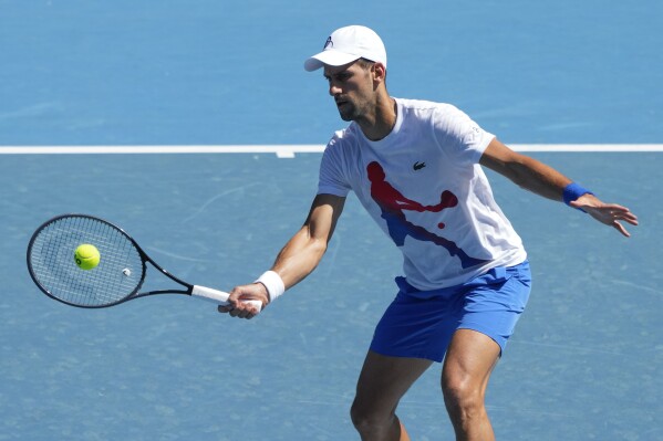 Serbia's Novak Djokovic plays a forehand return to during a practice session on Rod Laver Arena ahead of the Australian Open tennis championships at Melbourne Park, Melbourne, Australia, Friday, Jan. 12, 2024. (AP Photo/Andy Wong)