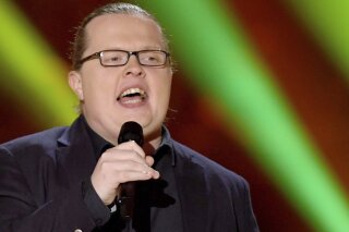 The singer Angelo Kelly Performer on stage in Berlin, Germany, Jan. 21, 2021. A Bavarian court has found the folk singer guilty of violating Germany’s strict child labor laws for having his 4-year-old son perform on stage with him during an evening concert in 2019. (Britta Pedersen/dpa via AP)