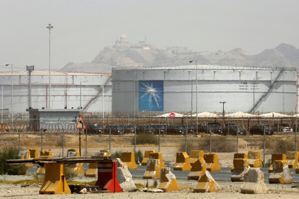 FILE - Storage tanks are seen at the North Jiddah bulk plant, an Aramco oil facility, in Jiddah, Saudi Arabia, on March 21, 2021. Saudi Arabia said Thursday, Aug. 3, 2023, it will extend its unilateral production cut of 1 million barrels of oil a day through the end of September in its effort to boost flagging energy prices. (AP Photo/Amr Nabil, File)