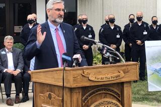 Indiana Gov. Eric Holcomb speaks during a bill signing ceremony at the Indiana Law Enforcement Academy in Plainfield, Ind., Monday, Aug. 16, 2021. Holcomb told reporters afterward that he supported the growing number of Indiana school districts issuing mask mandates for students and staff as they try to head off more COVID-19 outbreaks. (AP Photo/Tom Davies)