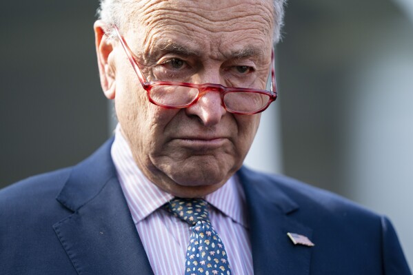 FILE - Senate Majority Leader Sen. Chuck Schumer of N.Y., talks with reporters after meeting with President Joe Biden at the White House, Oct. 31, 2023, in Washington. The Senate is heading for a vote on a temporary government funding package as lawmakers sought to keep the holiday season free from any suspense over a government shutdown. Senators were trying to speed forward on the funding package on Wednesday. (AP Photo/Evan Vucci)