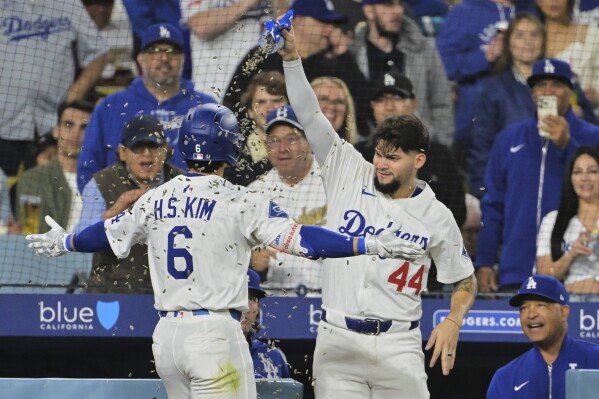 Los Angeles Dodgers' Hyeseong Kim (6) and Andy Pages (44) celebrate Kim's solo home run as manager Dave Roberts, bottom right, looks on in the fifth inning of a baseball game against the Oakland Athletics, Wednesday, May 14, 2025, in Los Angeles. (AP Photo/Jayne Kamin-Oncea)