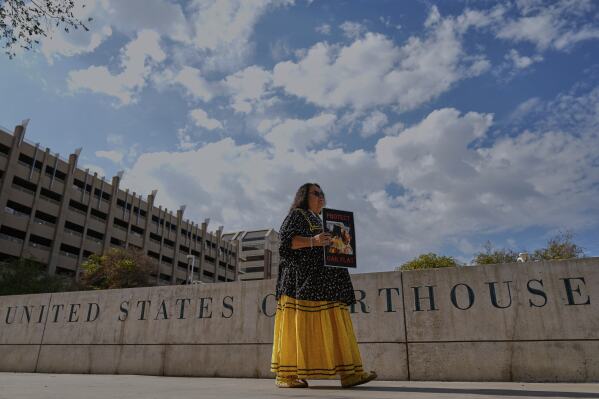 San Carlos Apache member Donna Cracium protests a massive copper mining project on federal land in Arizona outside the U.S. District Court, Wednesday, May 7, 2025, in Phoenix. (AP Photo/Matt York)