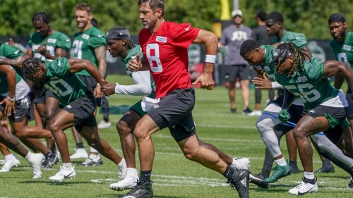 New York Jets quarterback Aaron Rodgers (8) warms up during practice at the NFL football team's training facility, Friday, July 21, 2023, in Florham Park, N.J. (AP Photo/John Minchillo)