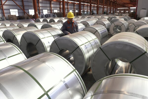 
              FILE - In this April 7, 2018, file photo, a worker checks on rolls of aluminum at a factory in Zouping county in east China's Shandong province. Small businesses are threatened by higher costs from U.S. steel and aluminum tariffs and by a broader trade fight with China, as steel costs are already higher since the Trump administration announced a 25 percent tariff on the metal in March. (Chinatopix via AP, File)
            