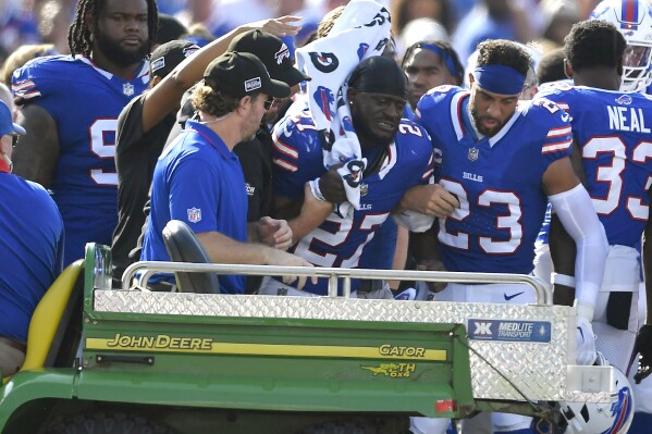 Buffalo Bills cornerback Tre'Davious White (27), center, is assisted onto the back of a cart after sustaining an injury during the second half an NFL football game against the Miami Dolphins, Sunday, Oct. 1, 2023, in Orchard Park, N.Y. (AP Photo/Adrian Kraus)