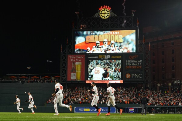 The clock atop the scoreboard at Oriole Park at Camden Yards is visible in  the first inning of a baseball game between the Baltimore Orioles and the  Boston Red Sox, Wednesday, April