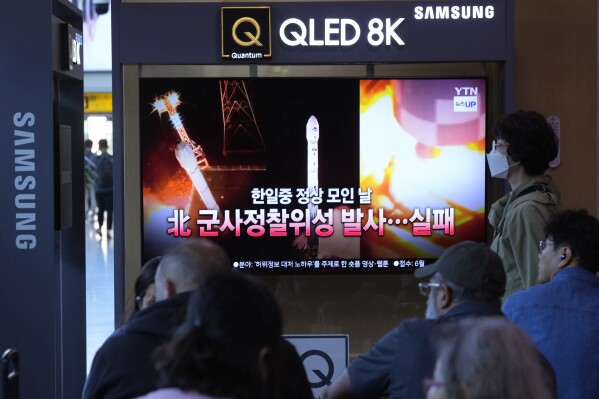 A news program broadcasts file images of a rocket launch by North Korea, at the Seoul Railway Station in Seoul, South Korea, Tuesday, May 28, 2024. A rocket launched by North Korea to deploy the country's second spy satellite exploded shortly after liftoff Monday, state media reported, in a setback for leader Kim Jong Un's hopes to field satellites to monitor the U.S. and South Korea. The writing on the screen reads "A North Korea spy satellite launch failed on a day when the leaders of South Korea, Japan and China gather." (AP Photo/Ahn Young-joon)