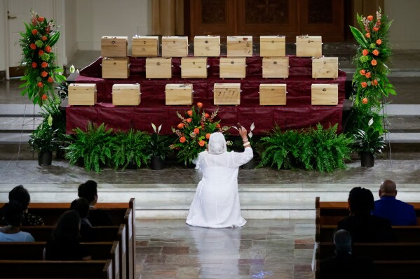 Nana Sula "Janet" Evans blesses the remains of 19 African Americans repatriated from Germany during their memorial service at Dillard University's Lawless Memorial Chapel in New Orleans, Saturday, May 31, 2025. (Scott Threlkeld/The Times-Picayune/The New Orleans Advocate via AP)