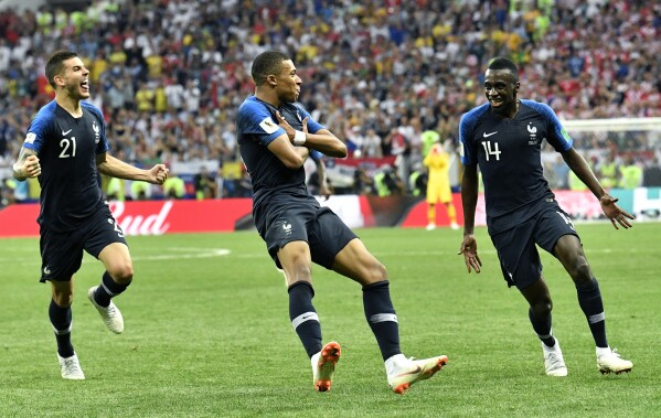 FILE - France's Kylian Mbappe, center, celebrates after scoring his side's fourth goal during the final match between France and Croatia at the 2018 soccer World Cup in the Luzhniki Stadium in Moscow, Russia, Sunday, July 15, 2018. Mbappe has told Paris Saint-Germain he will leave the club at the end of the season, it was reported on Thursday, Feb. 15, 2024. (AP Photo/Martin Meissner, File)