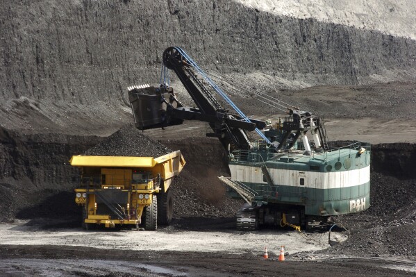 FILE - A mechanized shovel loads a haul truck that can carry up to 250 tons of coal at the Spring Creek coal mine, April 4, 2013, near Decker, Mont. On Wednesday, Feb. 21, 2024, a U.S. appeals court struck down a judge's 2022 order that imposed a moratorium on coal leasing from federal lands. (AP Photo/Matthew Brown, File)