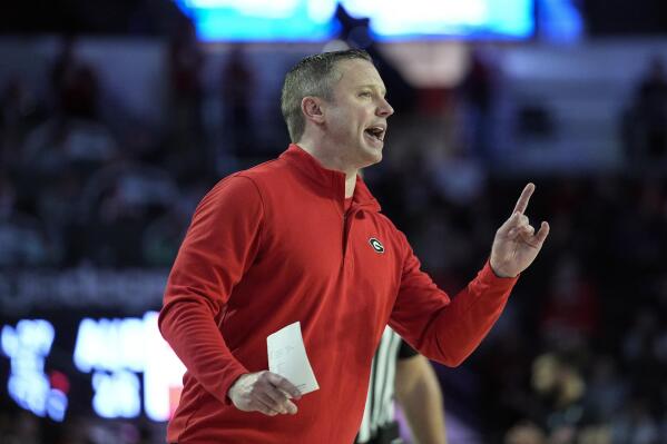 Georgia head coach Mike White yells to his players on the court during the first half of an NCAA college basketball game against Auburn, Jan. 4, 2023, in Athens, Ga. White is making an impact at Georgia, which is at .500 in the SEC at 4-4 following five consecutive losing seasons in the conference. Three of those SEC wins have come against teams currently tied for last in the league, but White says the ability to win close games gives the Bulldogs a chance to “steal a few” the remainder of the season. (AP Photo/John Bazemore)