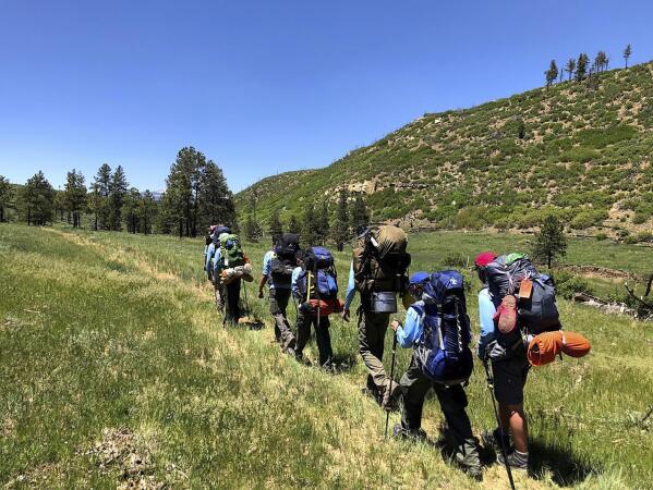 In this June 10, 2021 photo provided by Barry Bedlan, members of Troop 298 of Frisco, Texas are among the first to embark a 12-day trek across the Philmont Scout Ranch, outside Cimarron, N.M. Boy Scout and Girl Scouts’ leadership say their summer camps are full, special events are sold out, and they’re expecting many thousands of families – some new to scouting, some who left during the pandemic – to sign up now that activities are occurring in-person rather than virtually. (Barry Bedlan via AP)