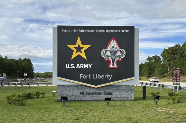 Vehicles pass a sign for Fort Liberty, an Army installation near Fayetteville, N.C., on Tuesday, Oct. 1, 2024. (AP Photo/Allen G. Breed)