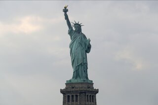 FILE - In this Aug. 14, 2019 file photo, The Statue of Liberty is shown in New York. The Department of Homeland Security says New York residents will be cut off from ‘trusted traveler’ programs because of a state law that prevents immigration officials from accessing motor vehicle records. Acting Deputy DHS Secretary Ken Cuccinelli says tens of thousands of New Yorkers will be inconvenienced by the action.  (AP Photo/Kathy Willens)