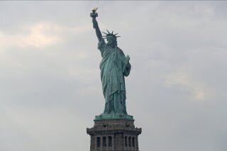 FILE - In this Aug. 14, 2019 file photo, The Statue of Liberty is shown in New York. The Department of Homeland Security says New York residents will be cut off from ‘trusted traveler’ programs because of a state law that prevents immigration officials from accessing motor vehicle records. Acting Deputy DHS Secretary Ken Cuccinelli says tens of thousands of New Yorkers will be inconvenienced by the action. (AP Photo/Kathy Willens)