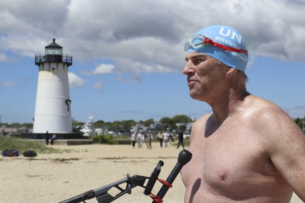 British South African endurance swimmer Lewis Pugh speaks with press directly after completing his 12-day 62-mile (100 kilometer) swim around the island of Martha's Vineyard, Mass., ahead of the 50th anniversary of the first blockbuster film "Jaws"' release, Monday, May 26, 2025. (AP Photo/Leah Willingham)