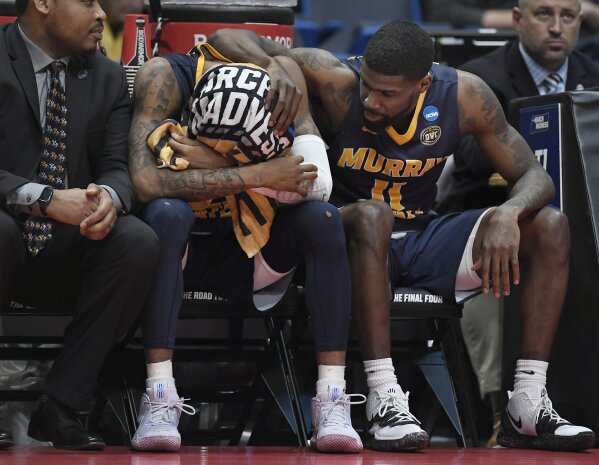 
              Murray State's Ja Morant, left is consoled by teammate Murray State's Shaq Buchanan, right, during the second half of a second round men's college basketball game against Florida State in the NCAA tournament, Saturday, March 23, 2019, in Hartford, Conn. (AP Photo/Jessica Hill)
            