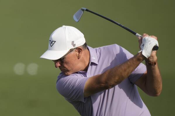 Phil Mickelson warms up on the driving range before a practice round in preparation for the Masters golf tournament at Augusta National Golf Club Wednesday, April 10, 2024, in Augusta, GA. (AP Photo/Charlie Riedel)