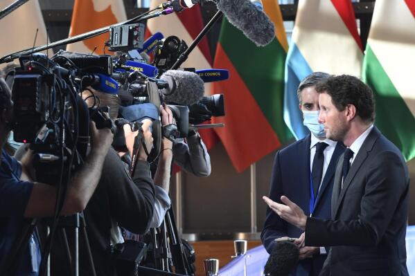 France's European Affairs Minister Clement Beune, right, speaks with the media as he arrives for a meeting of EU General Affairs ministers at the European Council building in Brussels, Tuesday, Sept. 21, 2021. European Union General Affairs ministers meet Tuesday to discuss the state of play in UK-EU relations and a submarine deal between the U.S., Britain and Australia, which led to France losing a contract to sell subs to Australia. (AP Photo/Geert Vanden Wijngaert)