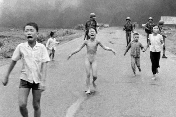 FILE - South Vietnamese forces follow terrified children, including 9-year-old Kim Phuc, center, as they run down Route 1 near Trang Bang after an aerial napalm attack on suspected Viet Cong hiding places on June 8, 1972. A South Vietnamese plane accidentally dropped its flaming napalm on South Vietnamese troops and civilians, and the terrified girl had ripped off her burning clothes while fleeing. (AP Photo/Nick Ut, File)