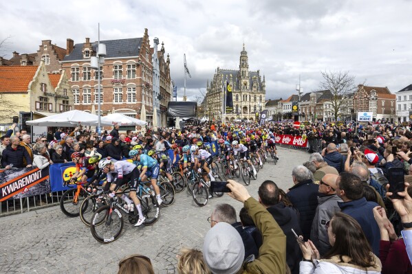 Norway's Vegard Stake Laengen of the UAE Team Emirates, third left, rides with the pack through the historical center of Oudenaarde, Belgium, during the Tour of Flanders on Sunday, March 31, 2024. (AP Photo/Geert Vanden Wijngaert)