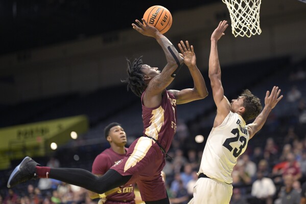 Florida State forward Jamir Watkins, left, is fouled by Colorado forward Tristan da Silva (23) while going up for a shot during the first half of an NCAA college basketball game, Tuesday, Nov. 21, 2023, in Daytona Beach, Fla. (AP Photo/Phelan M. Ebenhack)